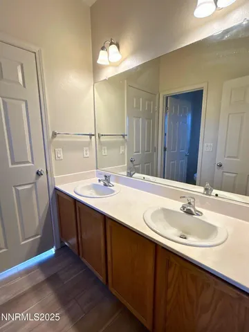 a bathroom with a sink double vanity and a mirror