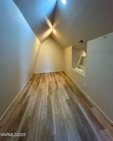 a view of an empty room and wooden floor