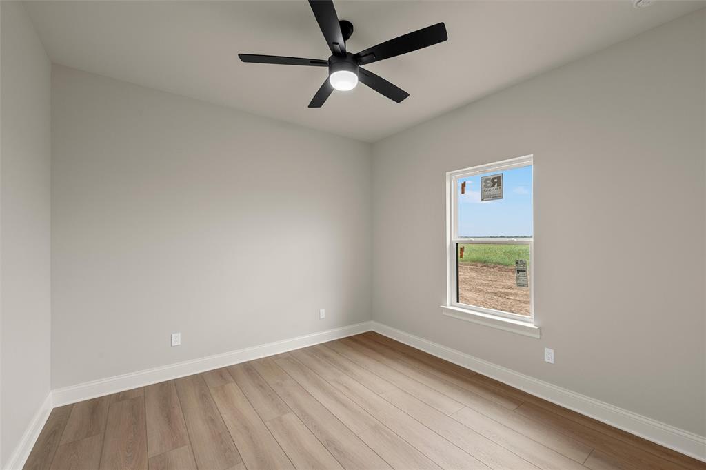 5200 Bogey Lane Waco, TX 76708 - Photo 16 of 37 an empty room with a window and a fan