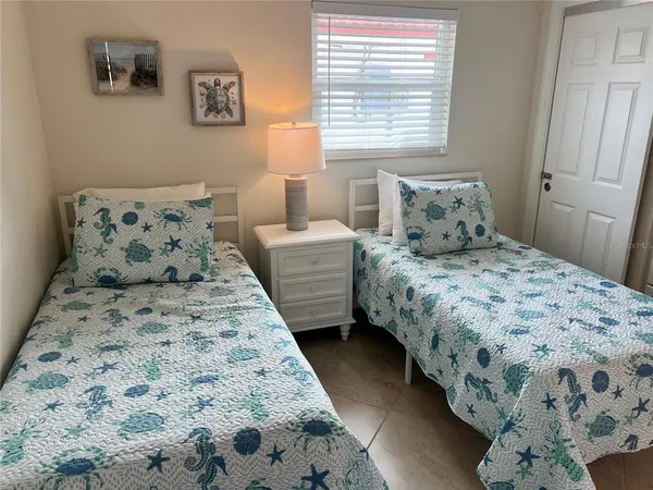 a bedroom with bed and window