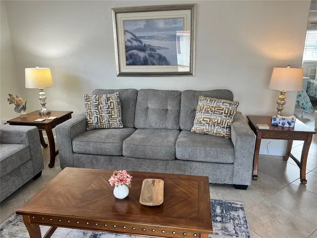 a living room with furniture and a lamp