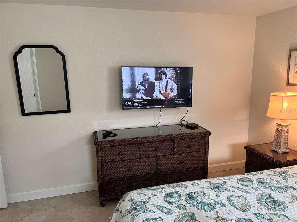 6154 Midnight Pass Road, Unit B07 Sarasota, FL 34242 - Photo 9 of 15 a bedroom with a bed and dresser