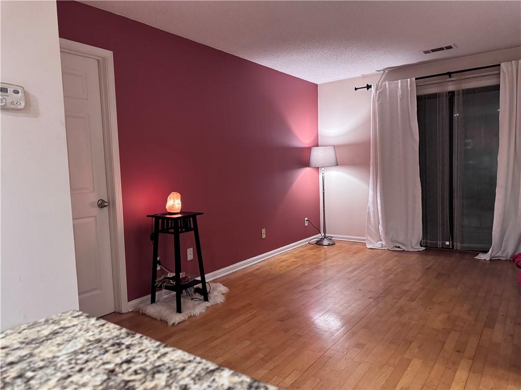 2657 Lenox Road Northeast, Unit 67 Atlanta, GA 30324 - Photo 1 of 1 a view of empty room with wooden floor