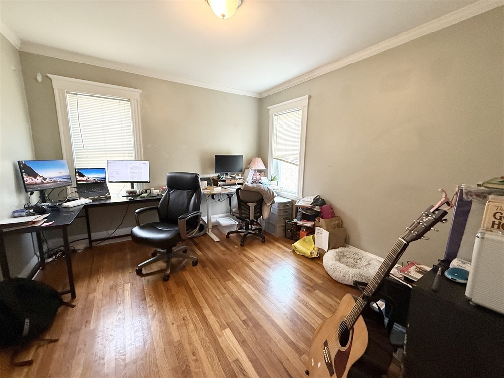 81 Florence Street, Unit 2 Boston, MA 02131 - Photo 8 of 11 a workspace with furniture hardwood and a window