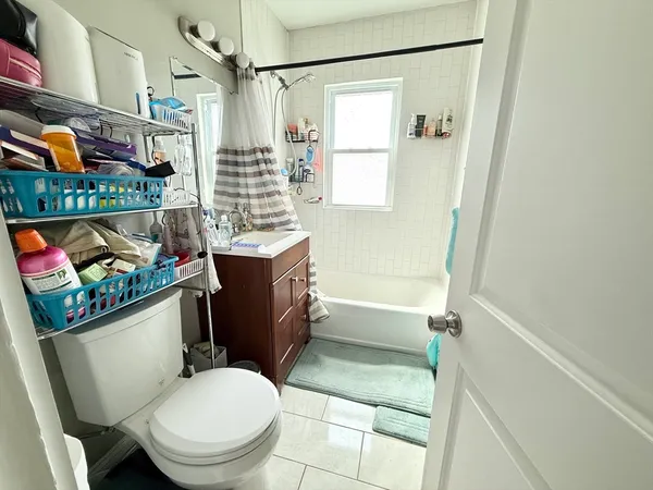a bathroom with a toilet a sink and a shower