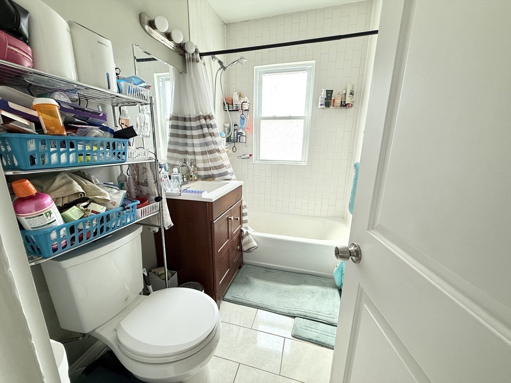 81 Florence Street, Unit 2 Boston, MA 02131 - Photo 9 of 11 a bathroom with a toilet a sink and a shower