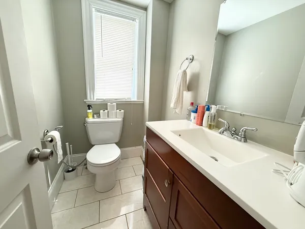 a bathroom with a sink toilet and mirror