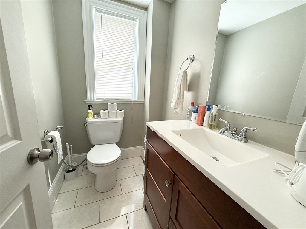 81 Florence Street, Unit 2 Boston, MA 02131 - Photo 10 of 11 a bathroom with a sink toilet and mirror