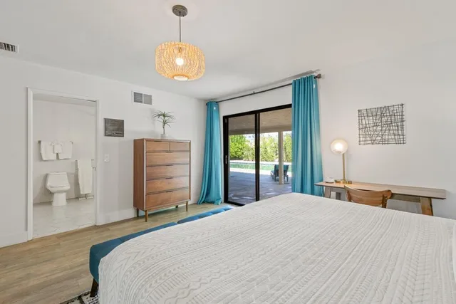 a bedroom with a bed and dresser