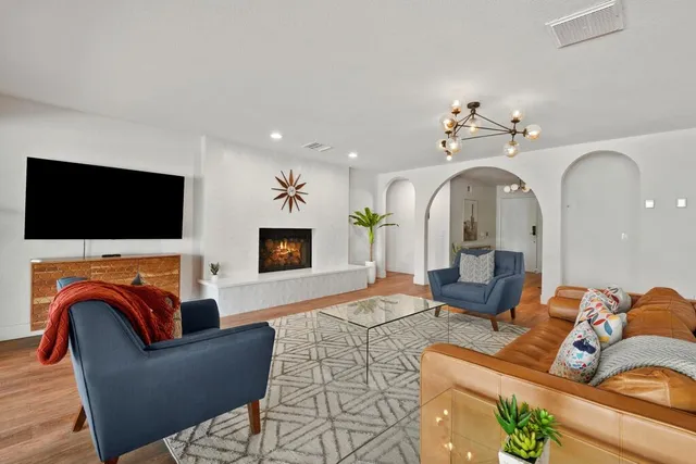 a living room with furniture and a floor to ceiling window