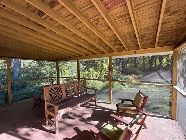 a view of a patio with table and chairs and wooden floor