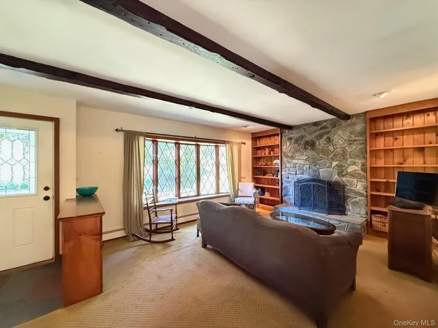 a living room with fireplace furniture and a flat screen tv
