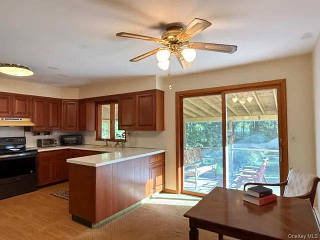 a kitchen with stainless steel appliances granite countertop a sink a stove and a refrigerator