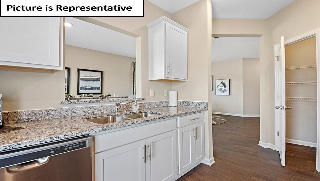7104 North Mill Road Charlotte, NC 28216 - Photo 12 of 26 a kitchen with granite countertop a sink and cabinets