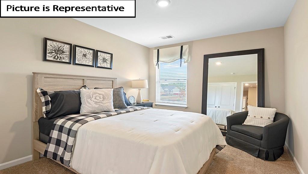 7104 North Mill Road Charlotte, NC 28216 - Photo 21 of 26 a bedroom with a bed and a painting on the wall
