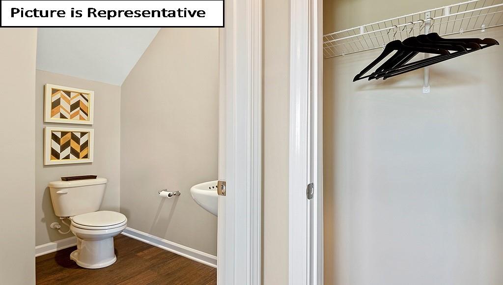 7104 North Mill Road Charlotte, NC 28216 - Photo 9 of 26 a white toilet sitting next to a bathroom sink
