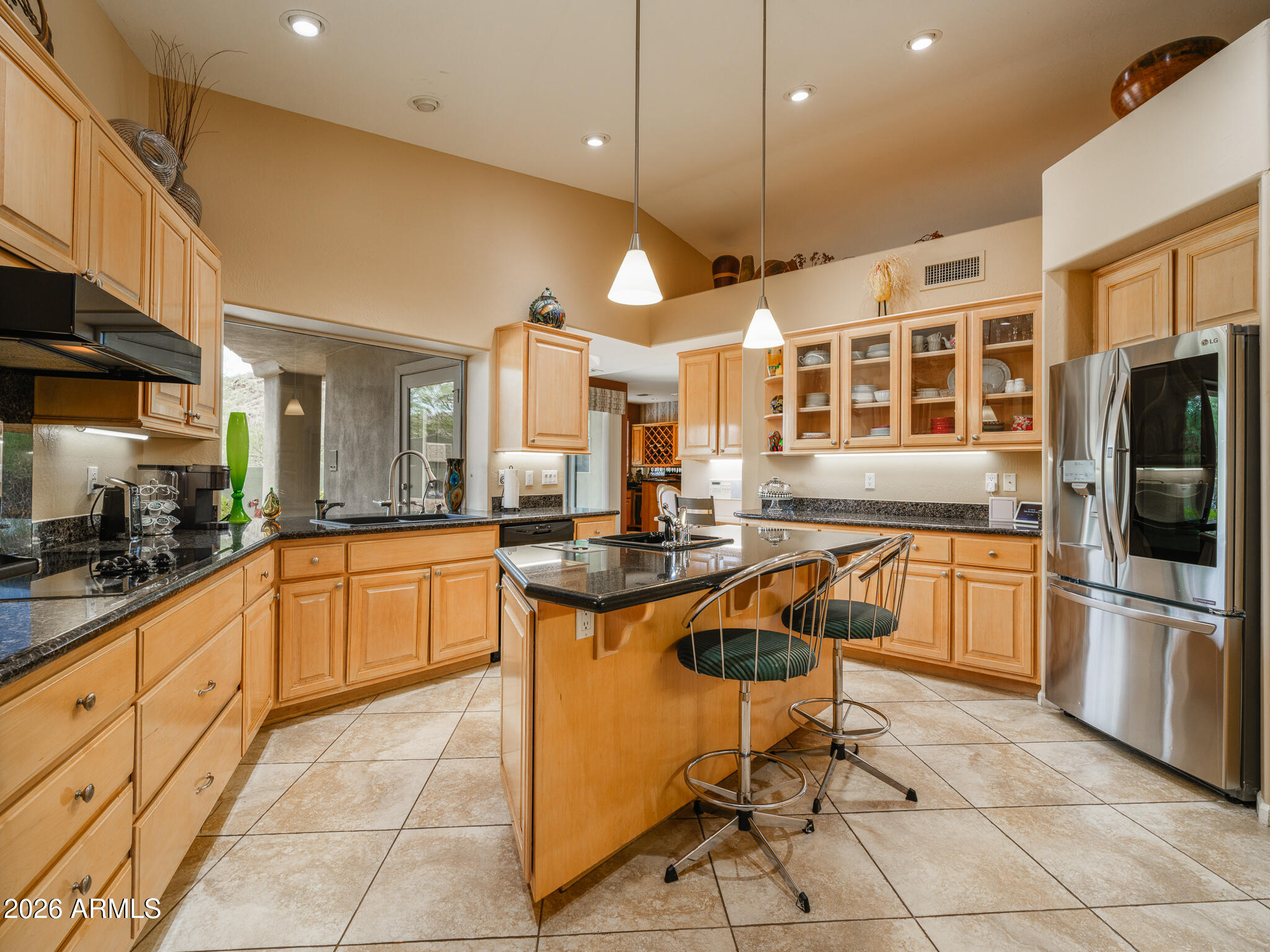 2329 East Hatcher Road Phoenix, AZ 85028 - Photo 10 of 40 a kitchen with stainless steel appliances granite countertop a stove a sink a oven a dining table and chairs