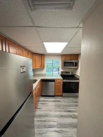 a kitchen with stainless steel appliances a refrigerator and a stove