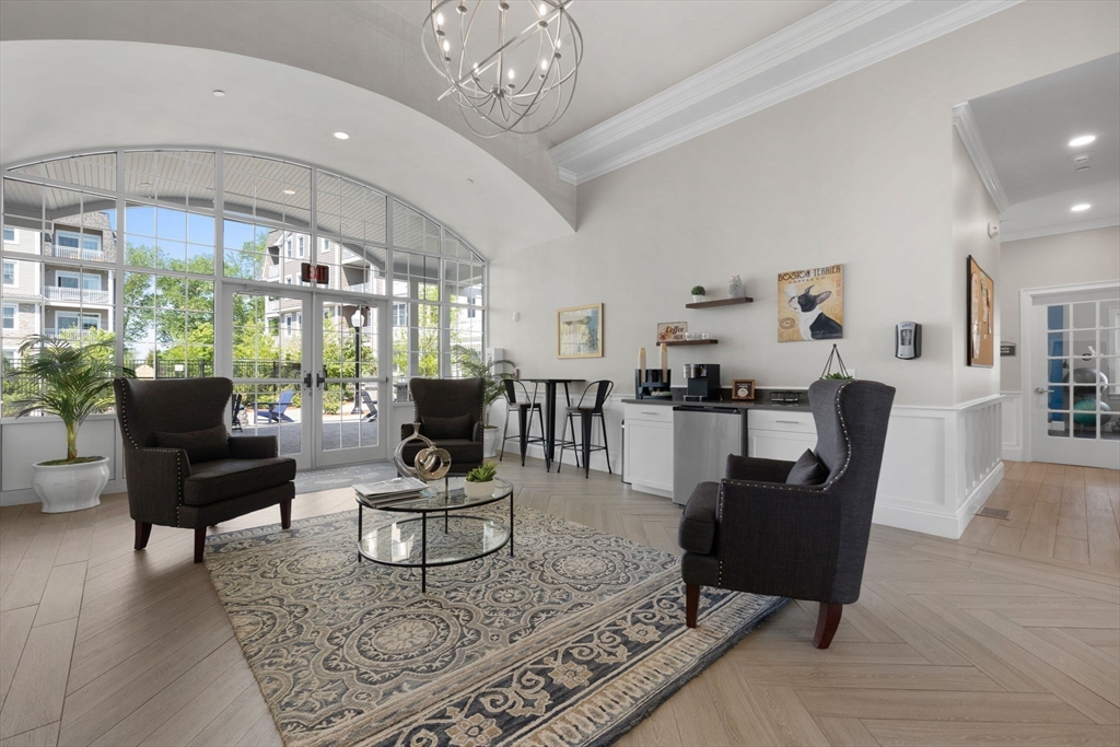 320 Middlesex Avenue, Unit B109 Medford, MA 02155 - Photo 14 of 21 a living room with furniture a chandelier and a rug