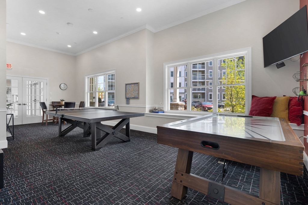 320 Middlesex Avenue, Unit B109 Medford, MA 02155 - Photo 17 of 21 a living room with furniture and a flat screen tv
