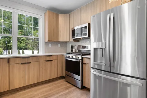 a kitchen with stainless steel appliances a refrigerator sink and microwave