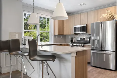 a kitchen with kitchen island a stove a sink and a refrigerator