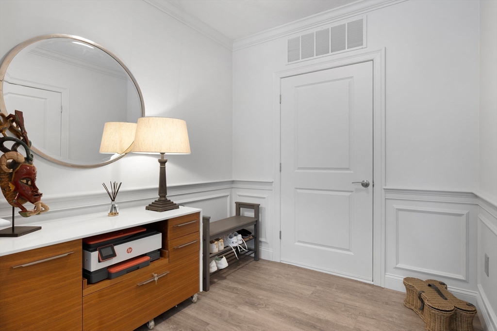 320 Middlesex Avenue, Unit B109 Medford, MA 02155 - Photo 10 of 21 a room with chandelier and wooden floor