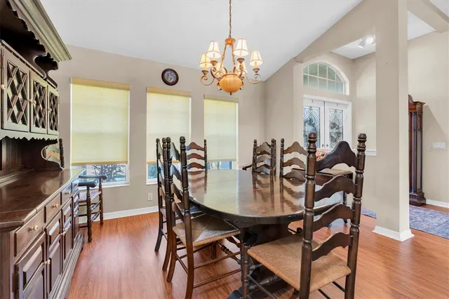 a view of a dining room with furniture wooden floor and chandelier