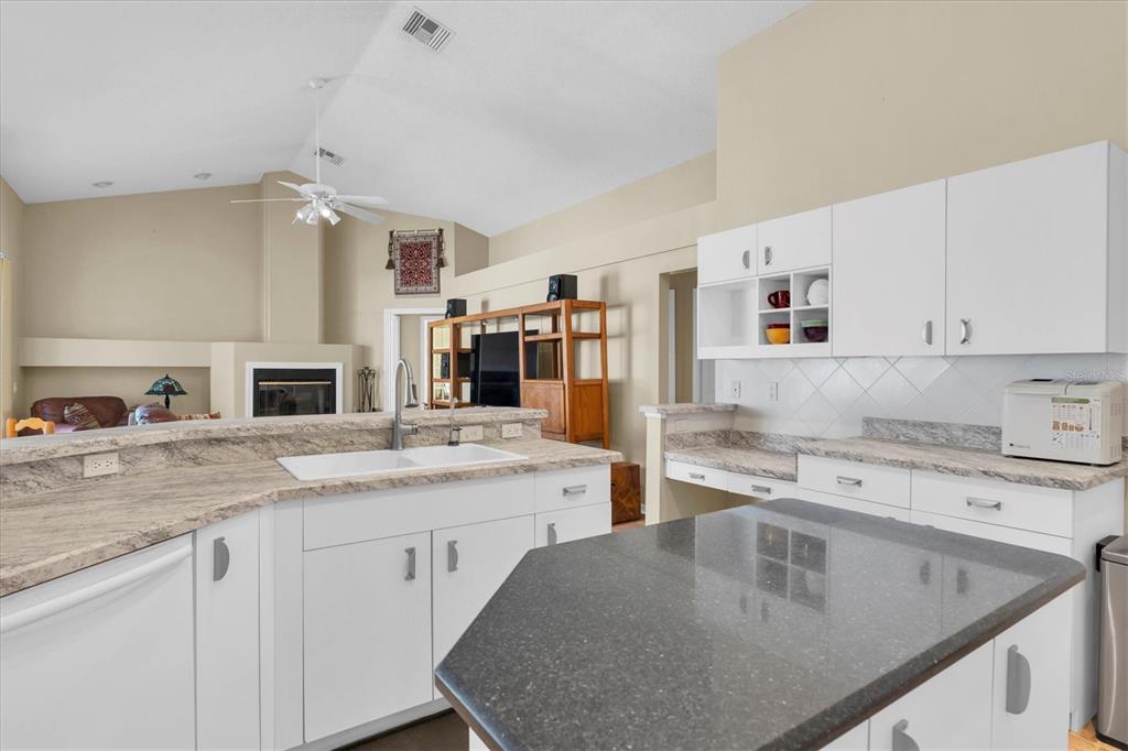 1226 Hoversham Drive New Port Richey, FL 34655 - Photo 18 of 41 a kitchen with a stove a sink a refrigerator and cabinets