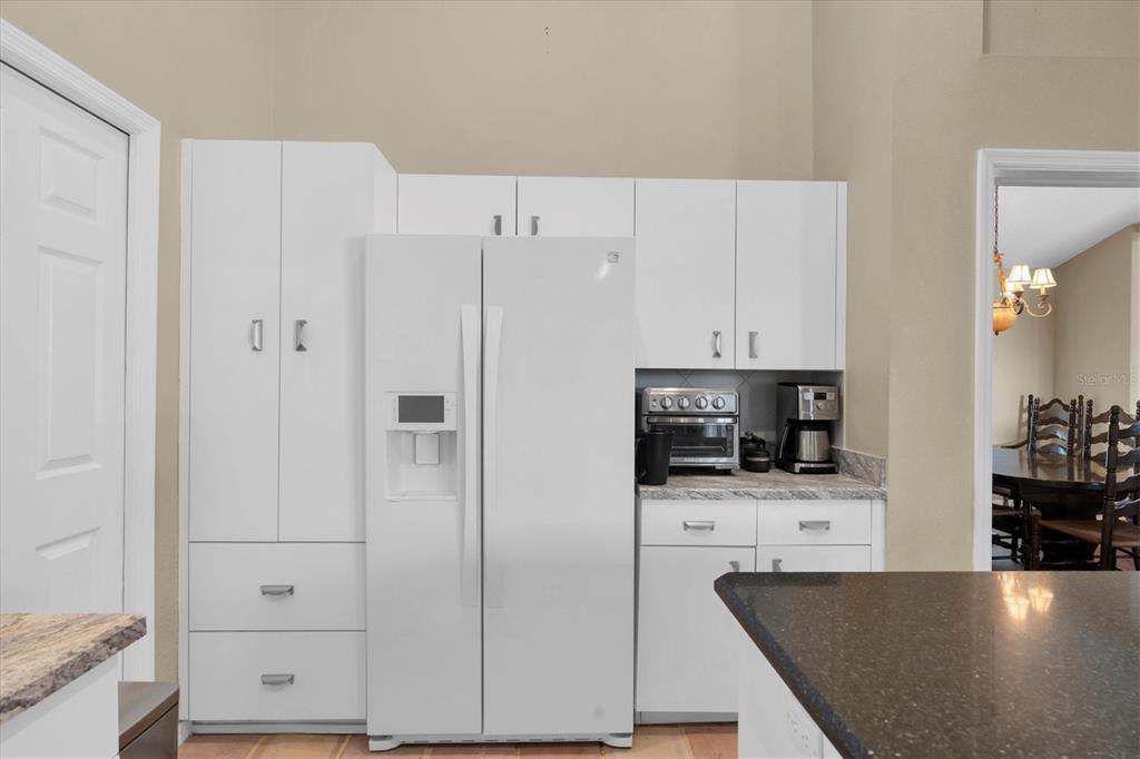 1226 Hoversham Drive New Port Richey, FL 34655 - Photo 19 of 41 a kitchen with stainless steel appliances a refrigerator a stove a microwave and cabinets