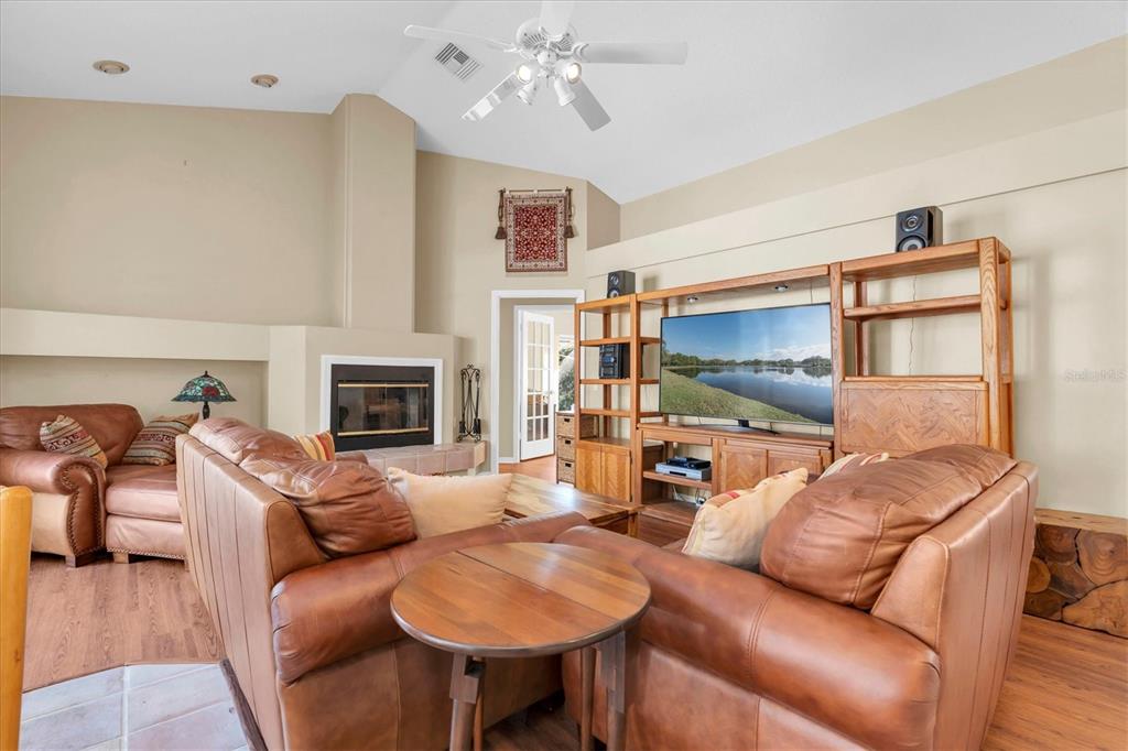 1226 Hoversham Drive New Port Richey, FL 34655 - Photo 22 of 41 a living room with furniture a flat screen tv and a fireplace
