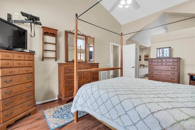 a bedroom with a bed and flat screen tv