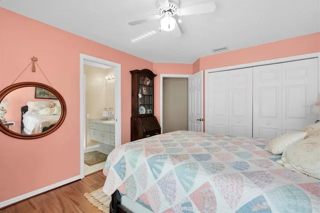a bedroom with a large bed and a chandelier