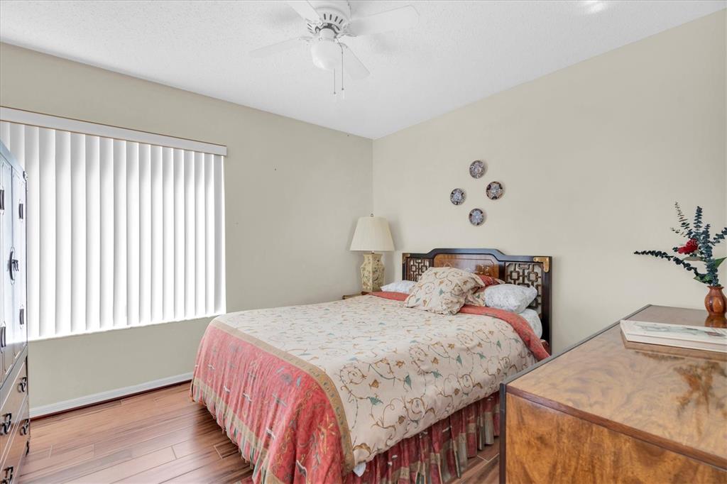 1226 Hoversham Drive New Port Richey, FL 34655 - Photo 30 of 41 a bedroom with a bed and wooden floor