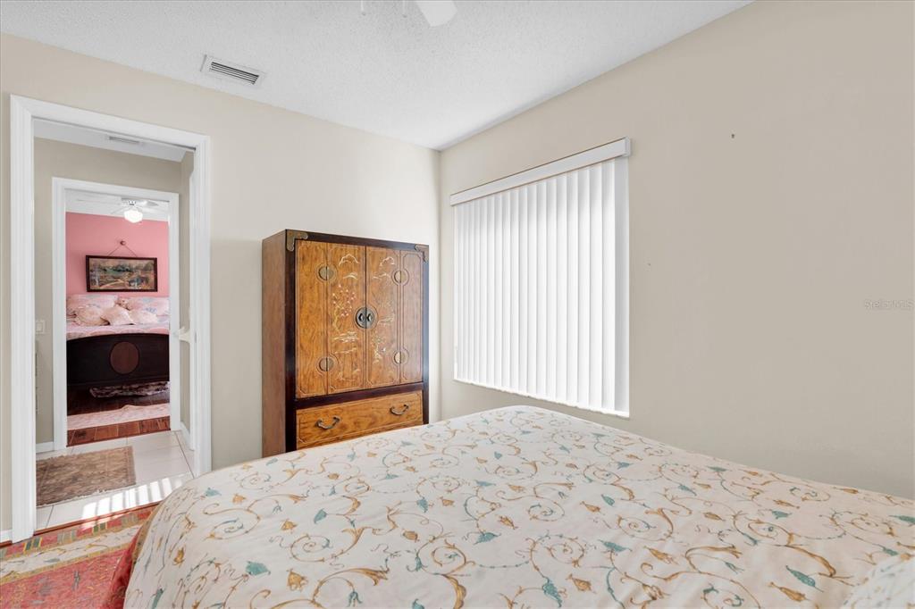 1226 Hoversham Drive New Port Richey, FL 34655 - Photo 31 of 41 a bedroom with a bed and a flat screen tv