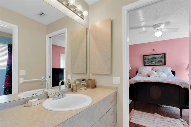 a en suite bathroom with a sink and a mirror