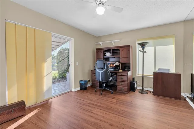a view of a livingroom with workspace and a window