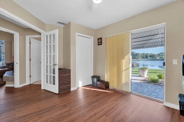 an empty room with wooden floor and door