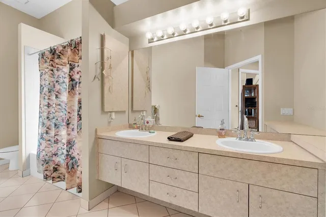 a bathroom with a double vanity sink mirror and double
