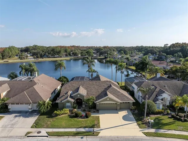 an aerial view of a house with a lake view