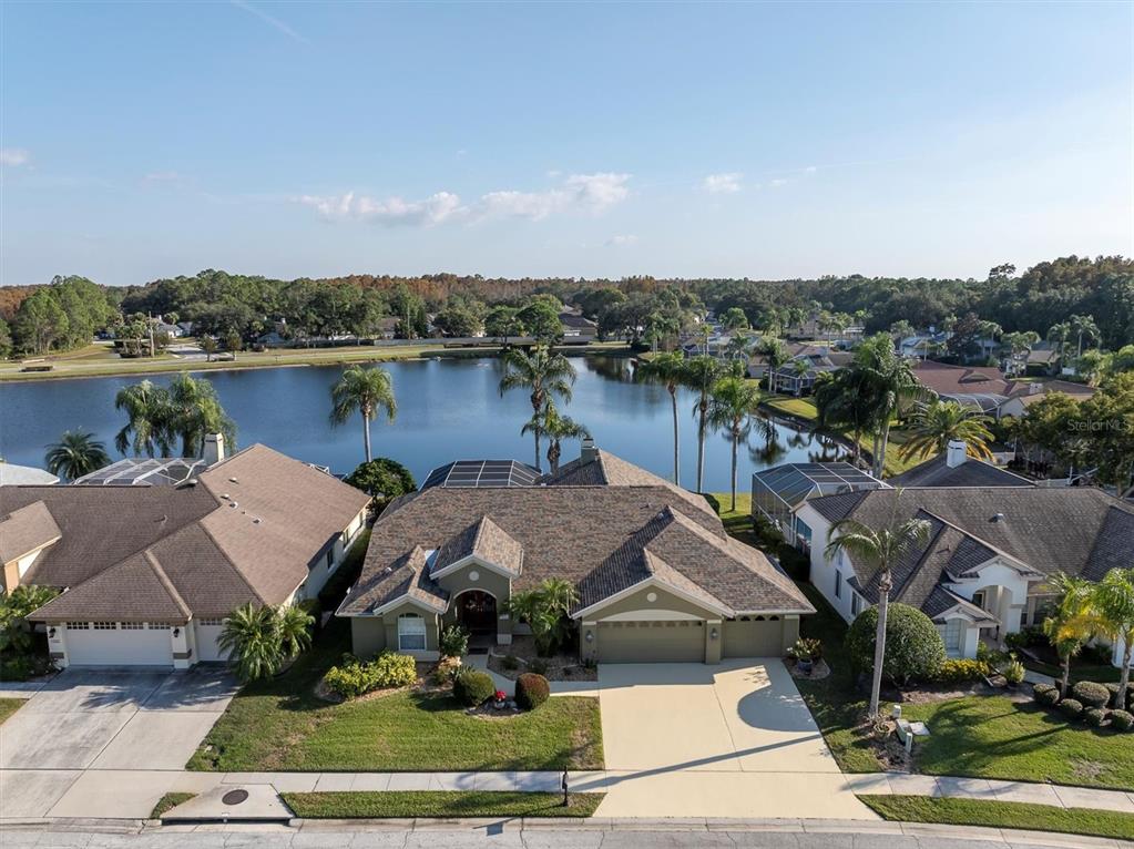 1226 Hoversham Drive New Port Richey, FL 34655 - Photo 4 of 41 an aerial view of a house with a lake view