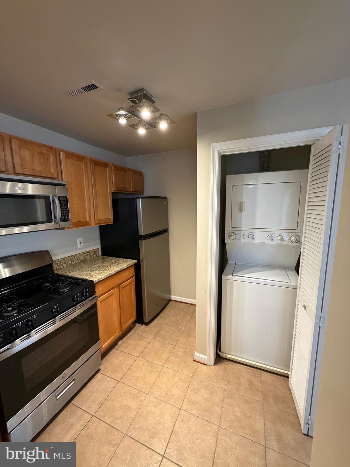 2514 Markham Lane, Unit 3 Landover, MD 20785 - Photo 11 of 13 a kitchen with stainless steel appliances granite countertop a refrigerator and a stove