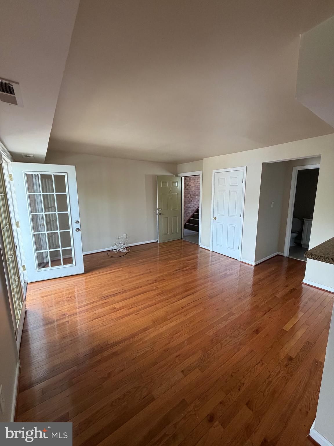 2514 Markham Lane, Unit 3 Landover, MD 20785 - Photo 12 of 13 an empty room with wooden floor and windows