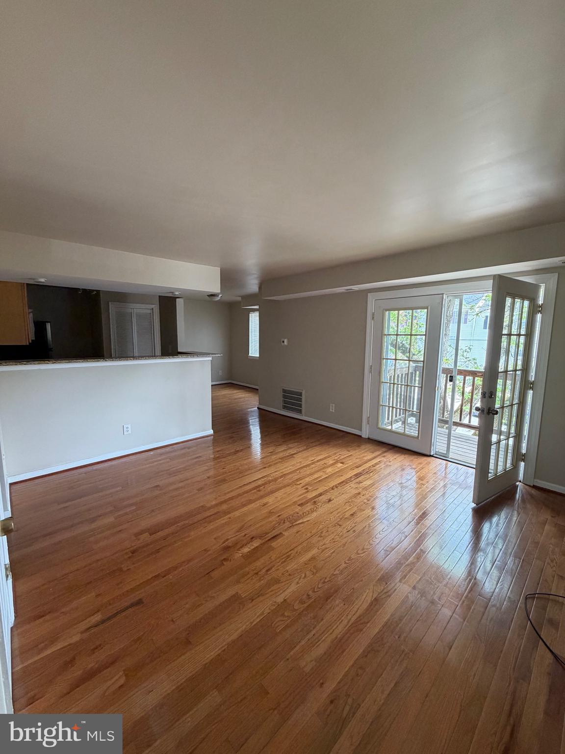 2514 Markham Lane, Unit 3 Landover, MD 20785 - Photo 3 of 13 a view of an empty room with wooden floor and a window