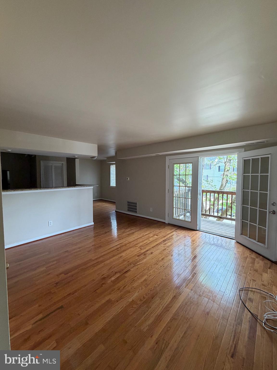 2514 Markham Lane, Unit 3 Landover, MD 20785 - Photo 4 of 13 a view of an empty room with wooden floor and a window