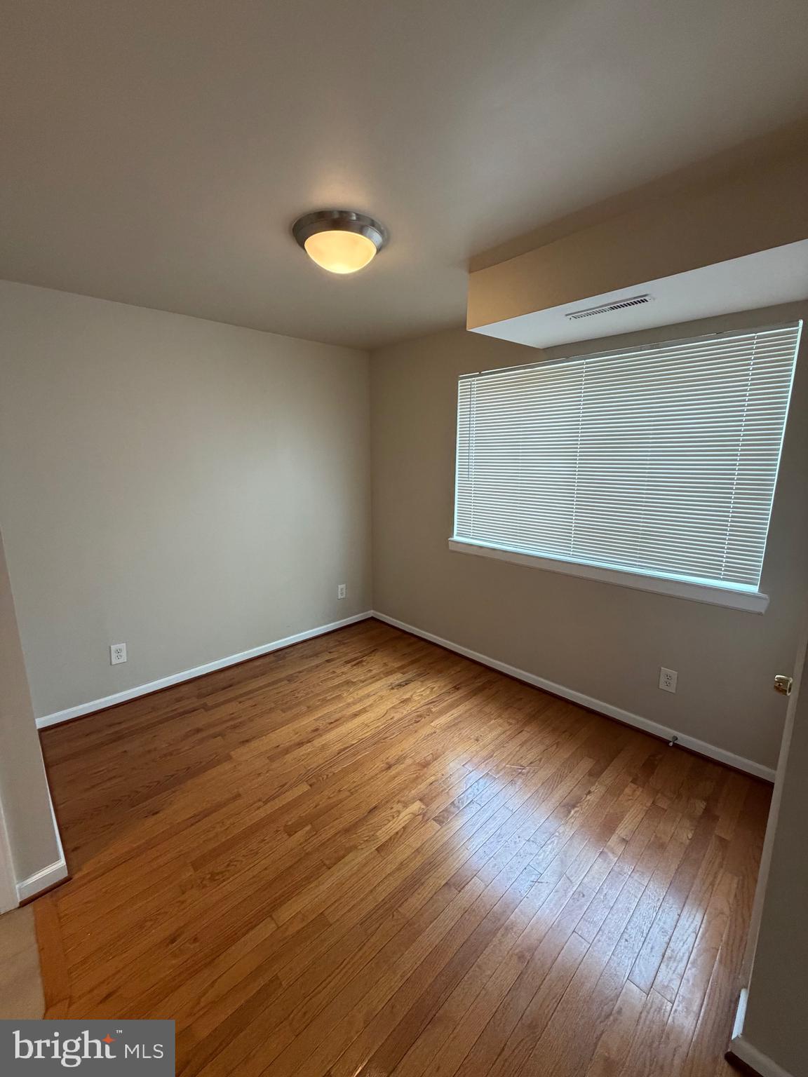2514 Markham Lane, Unit 3 Landover, MD 20785 - Photo 7 of 13 an empty room with wooden floor and windows