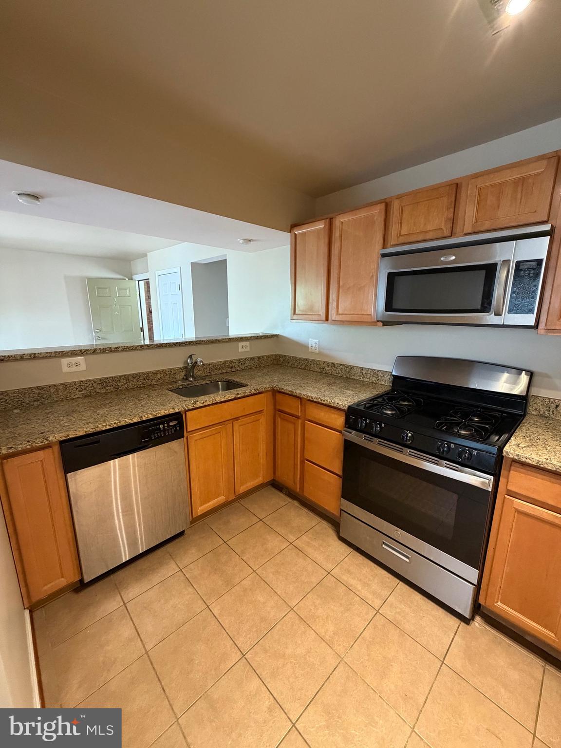 2514 Markham Lane, Unit 3 Landover, MD 20785 - Photo 10 of 13 a kitchen with stainless steel appliances granite countertop a stove and a sink