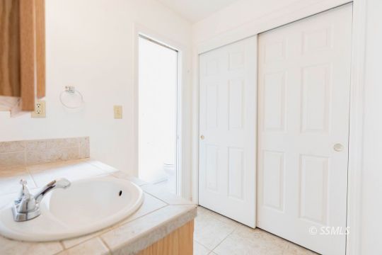 929 South Ranger Street Ridgecrest, CA 93555 - Photo 17 of 25 a bathroom with a sink and a mirror