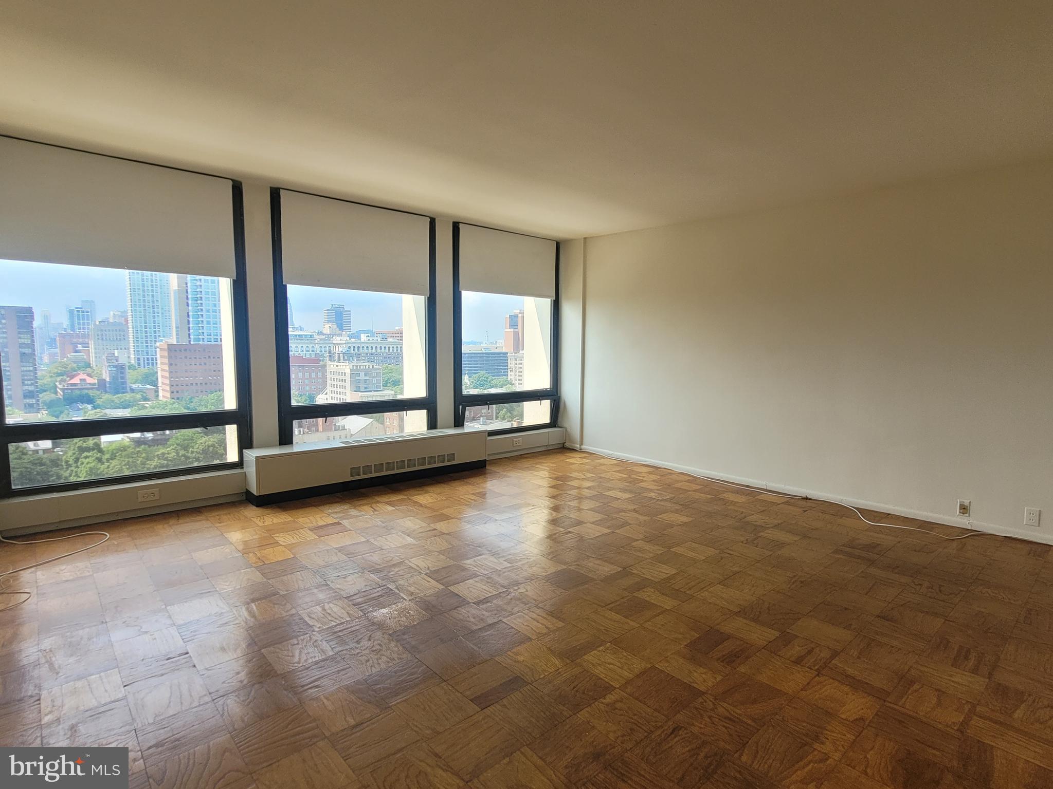 wooden floor in an empty room with a large window