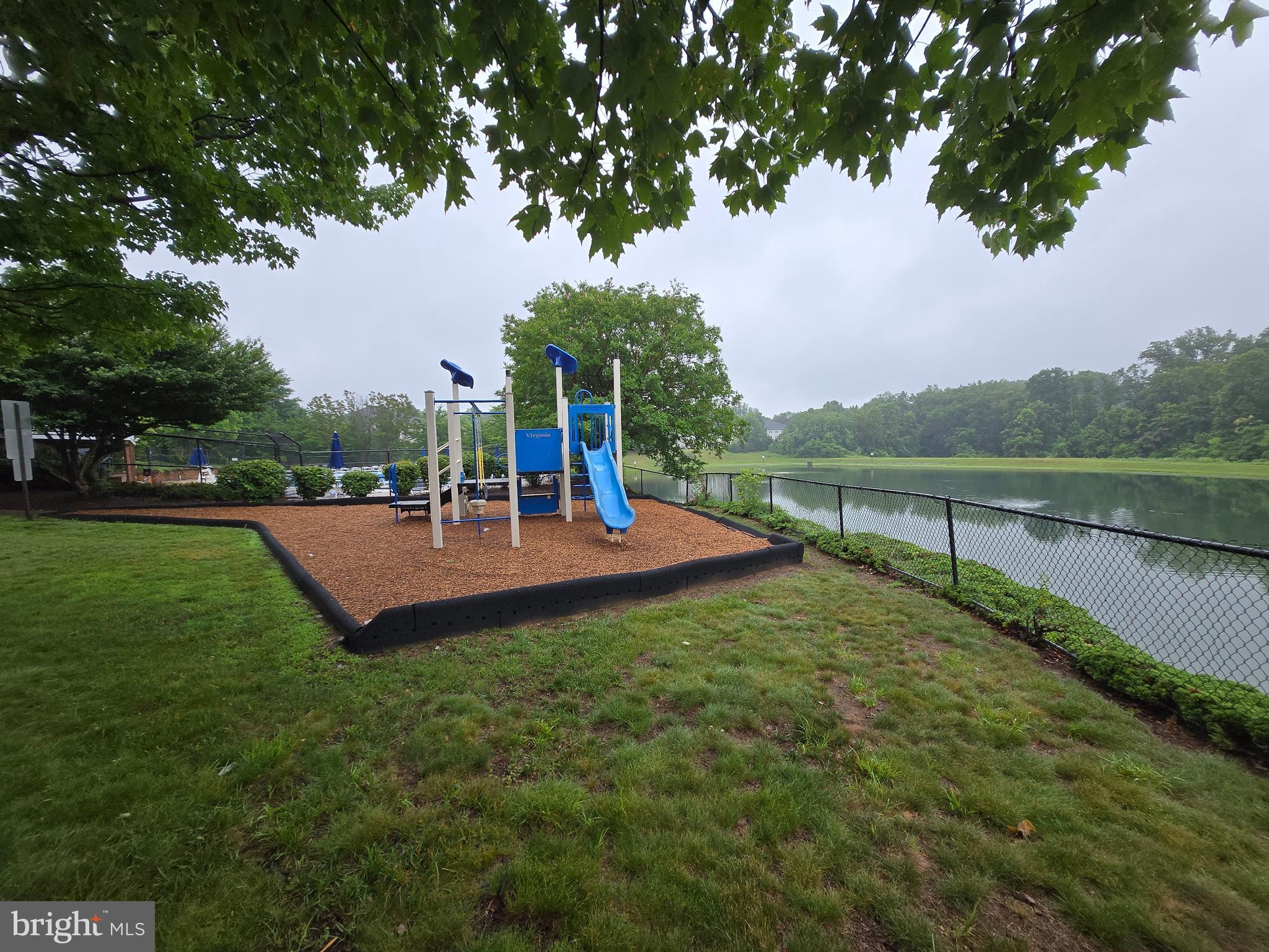14151 Cuddy Loop, Unit 101 Woodbridge, VA 22193 - Photo 40 of 45 a view of a garden with a bench in the park